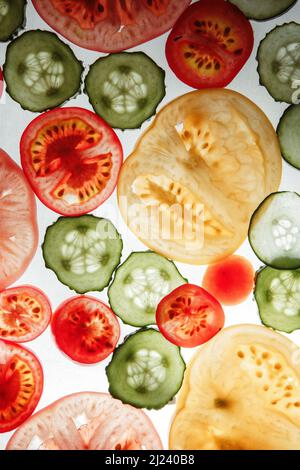 cucumbers and tomatoes sliced ??on a white background Stock Photo