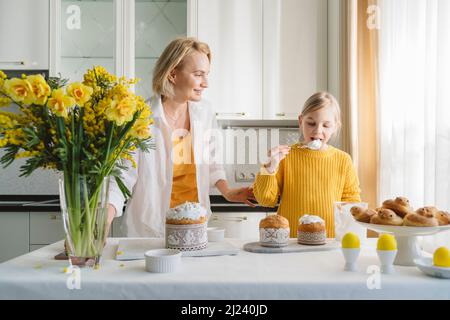 Mom and daughter cook together in the kitchen. Stock Photo