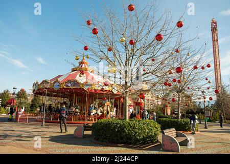 Sochi, Russia - January 02 2022: Colorful Carousel Attraction Ride With Wooden Horses. Children's carousel of attractions in the Sochipark amusement Stock Photo