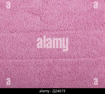 Close up pink microfiber washcloth, household cleaning wipe or towel background texture Stock Photo