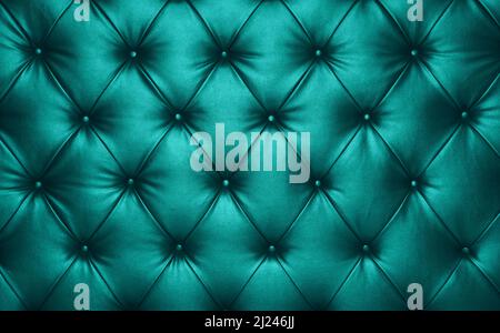 Close up background texture of turquoise teal blue capitone genuine leather, retro Chesterfield style soft tufted furniture upholstery with deep diamo Stock Photo