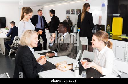 business people chatting while enjoying coffee Stock Photo