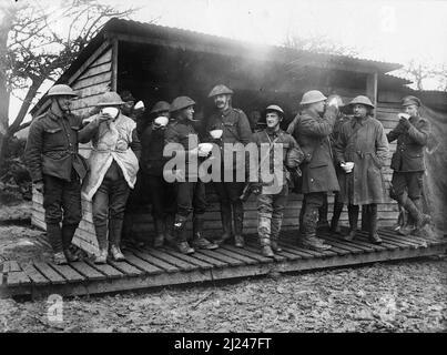 British troops at a Y.M.C.A. soup stall, Mailly Maillet, October 1916. The group includes soldiers from the Royal Field Artillery, 24th Battalion (County of London), London Regiment (The Queen's), the South Staffordshire Regiment and a Pioneer Battalion. Stock Photo
