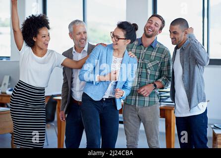Theyre one amazing team. a group of happy coworkers celebrating