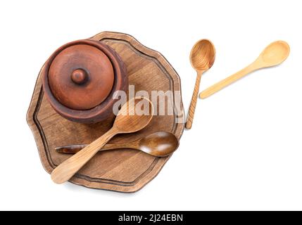 Stylish jug and wooden spoons on white background Stock Photo