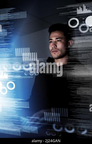 Scrutinizing his code. Shot of a focussed computer programmer working at his computer late at night. Stock Photo