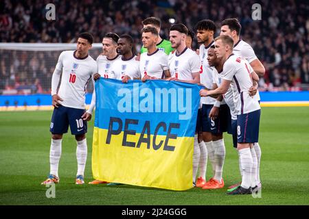 LONDON, ENGLAND - MARCH 29: Ollie Watkins, Tyrick Mitchell, James Ward-Prowse, Declan Rice, Harry Maguire, Ben White, Jack Grealish, Tyrone Mings of England hold Flag of Ukraine before the International Friendly match between England and Ivory Coast at Wembley Stadium on March 29, 2022 in London, England. (Photo by Sebastian Frej) Credit: Sebo47/Alamy Live News Stock Photo