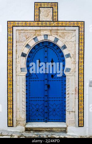 View of the typical front facade of a house in the Mediterranean city of Sidi Bou Said, a town in northern Tunisia located about 20 km from Tunis Stock Photo