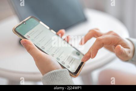 woman looking for the right contact on the phone. Woman hands with cellphone. Cropped shot view of woman hands holding mobile phone with contacts Stock Photo