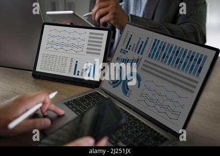 Two Businessman data analysis profit on the computer screen analyzing data marketing planning finance sales data Stock Photo
