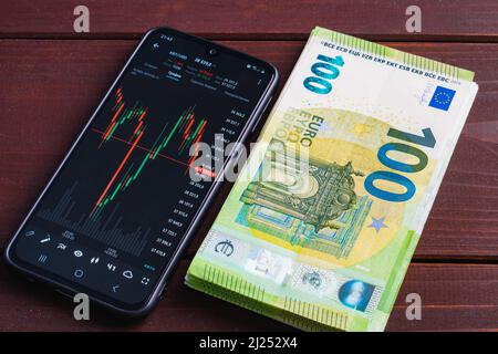 Various currency exchange rate chart on smartphone screen. Smart gadget on  pile of euro banknotes Stock Photo - Alamy