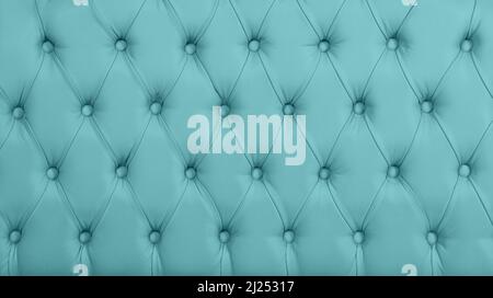 Close up background texture of pastel blue capitone genuine leather, retro Chesterfield style soft tufted furniture upholstery with deep diamond patte Stock Photo