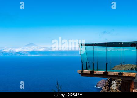 Agulo, Spain - August 9, 2021: Abrante Viewpoint. It has a famous walkway with a glass floor facing Teide Volcano Stock Photo