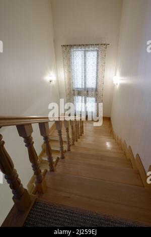 Classic simple wooden stairs in the house, stairs between floors. Stock Photo