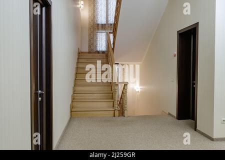 Classic simple wooden stairs in the house, stairs between floors. Stock Photo