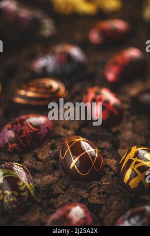 Easter chocolate eggs with different pattern, homemade craft chocolate for Easter holiday Stock Photo