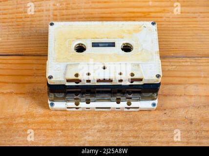 Old Audio Cassettes on a Wooden Planks Background closeup Stock Photo