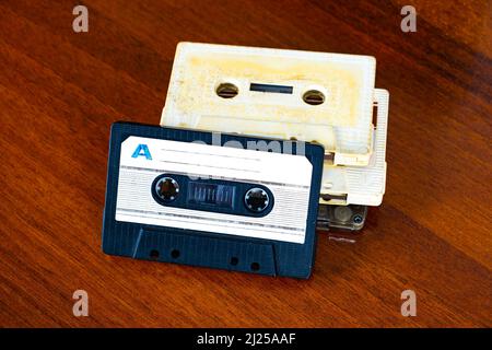 Old Audio Tape Cassettes on a Wooden Table Background closeup Stock Photo