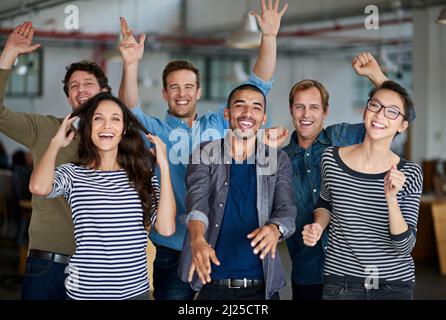 Now thats what I call team spirit. Joyous group of office staff jumping around and having fun together. Stock Photo