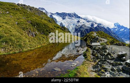 One of the Sealy Tarns and the viewpoint on the route to Mueller Hut. Mount Sefton in the background. Aoraki/Mount Cook National Park, New Zealand. Stock Photo