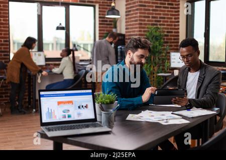 Multiethnic businesspeople planning business collaboration analyzing marketing strategy working at financial project in startup office. Diverse team brainstorming ideas planning collaboration Stock Photo