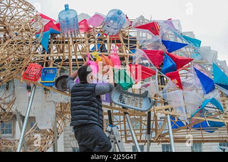 London UK 30 March 2022 Somerset House presents  The Arks of Gimokudan by the brilliant Philippine artist Leeroy New, which can be seen giving the last touches to the installation. Paul Quezada-Neiman/Alamy Live News Stock Photo