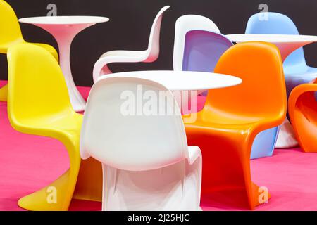 Contemporary multi colored plastic chairs and tables. Kindergarten interior Stock Photo