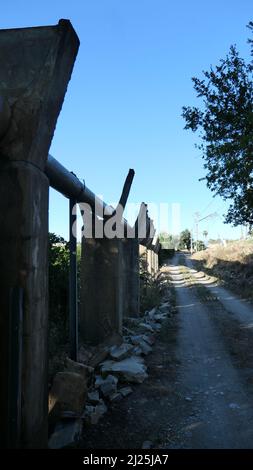 View of a road and irrigation canal winding through lush green rice ...