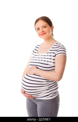 Pregnant woman standing embracing her belly Stock Photo