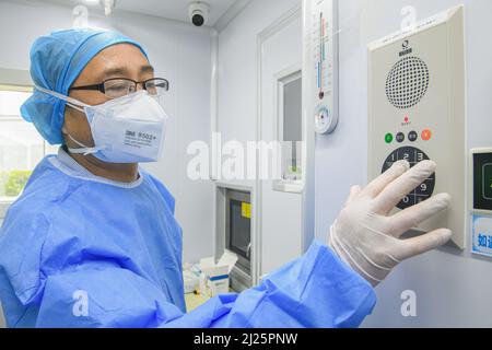 HEFEI, CHINA - MARCH 30, 2022 - An inspector uses an intercom device to contact other inspectors at the Deandi Mobile Rapid Inspection Laboratory at t Stock Photo