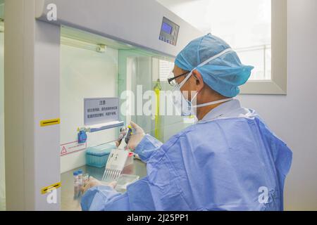 HEFEI, CHINA - MARCH 30, 2022 - An inspector mixes reagents at the DeAndi Mobile Rapid Inspection Laboratory at the Railway Station Square in Hefei, A Stock Photo