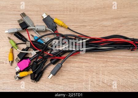 Bundle of various cables with various connectors suitable for different ports. Concept of great number of pc peripherals, equipments and connected dev Stock Photo