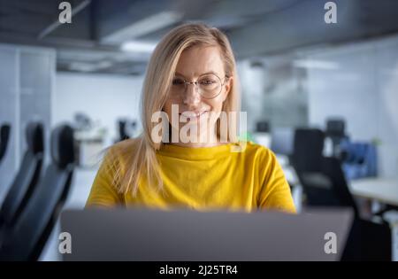 Woman working on laptop at office Stock Photo