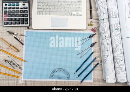 Workplace of engineer. Top view of laptop, notepad, and drawing tools Stock Photo