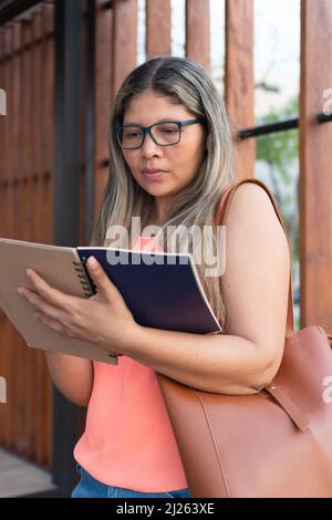 businesswoman making notes in diary Stock Photo