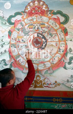 Pema Osel Ling Monastery.  The wheel of life or the bhavacakra  is a symbolic representation of saṃsara.  Wall painting. Stock Photo