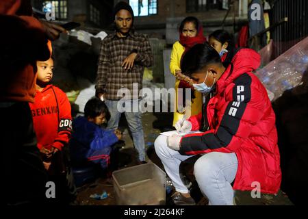 Night marauding in the street of Katmandu.  Distribution of medicines. Stock Photo