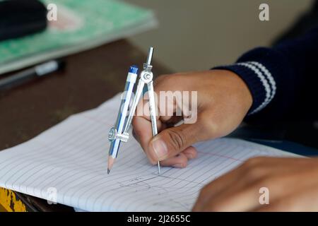 Primary school.  Classroom.  Pupil writing on notebook.  Close-up. Stock Photo