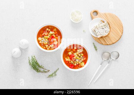 Tuscan tomato chickpea soup with various vegetables, thyme and parmesan cheese, top view Stock Photo