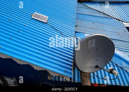 Parabol on a corrugated galvanised iron roof. Stock Photo
