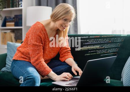 Woman writing code at home Stock Photo