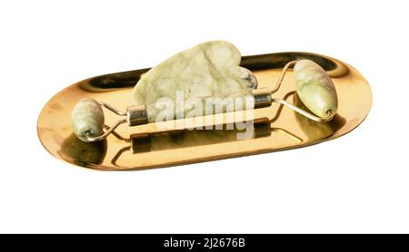 Gua Sha massage tools isolated on white background. Scraper and roller on stand. Beauty face and skin health concept. Lifting and anti-age treatment. Cosmetic natural trend. High quality photo Stock Photo