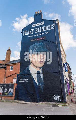 Large advert for final BBC series of Peaky Blinders featuring Cillian Murphy as Tommy Shelby painted on the wall of a building in Digbeth, Birmingham Stock Photo