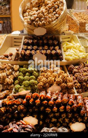 Traditional Turkish delicacies, nuts, dried fruits and desserts in Istanbul Spice Bazaar or Grand bazaar. dates, walnuts, pistachios, walnut pulp Stock Photo