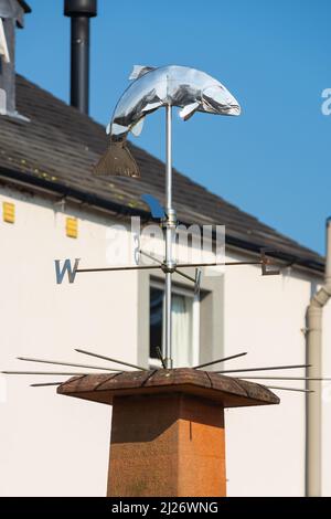 Wind vane in town center on a beautiful Spring day.  Pooley Bridge, England. Stock Photo