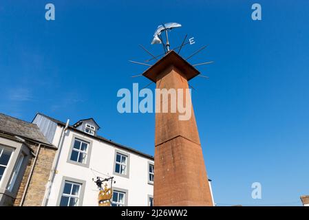 Wind vane in town center on a beautiful Spring day.  Pooley Bridge, England. Stock Photo