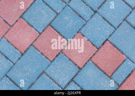 Gray sidewalk tile street stone city road abstract urban pattern color red blue pink design texture paving background. Stock Photo