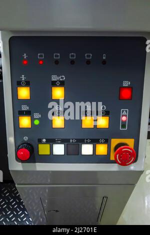 Boards with unit control buttons of an offset press machine. Paper Handling and Emergency Stop Button. Stock Photo