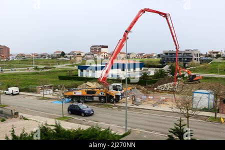 Mercedes Benz truck mounted 47.5 Putzmeister Concrete Pump being used at a construction site and a passing car Santander Spain Stock Photo