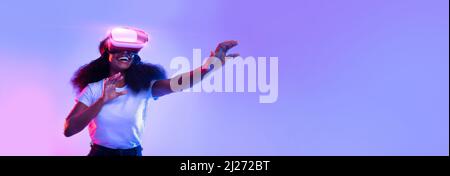 Excited young African American lady using VR glasses Stock Photo